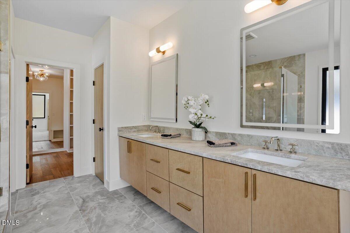 1213 Brookside Drive Raleigh, NC 27604 - Photo 35 of 50 a bathroom with double sink and a mirror