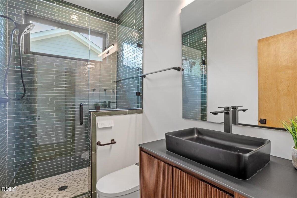1213 Brookside Drive Raleigh, NC 27604 - Photo 37 of 50 a bathroom with a toilet sink and shower