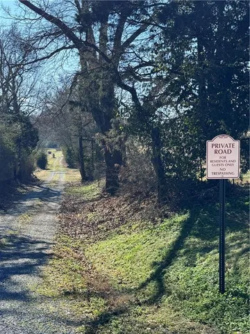 a sign that is sitting in the middle of forest