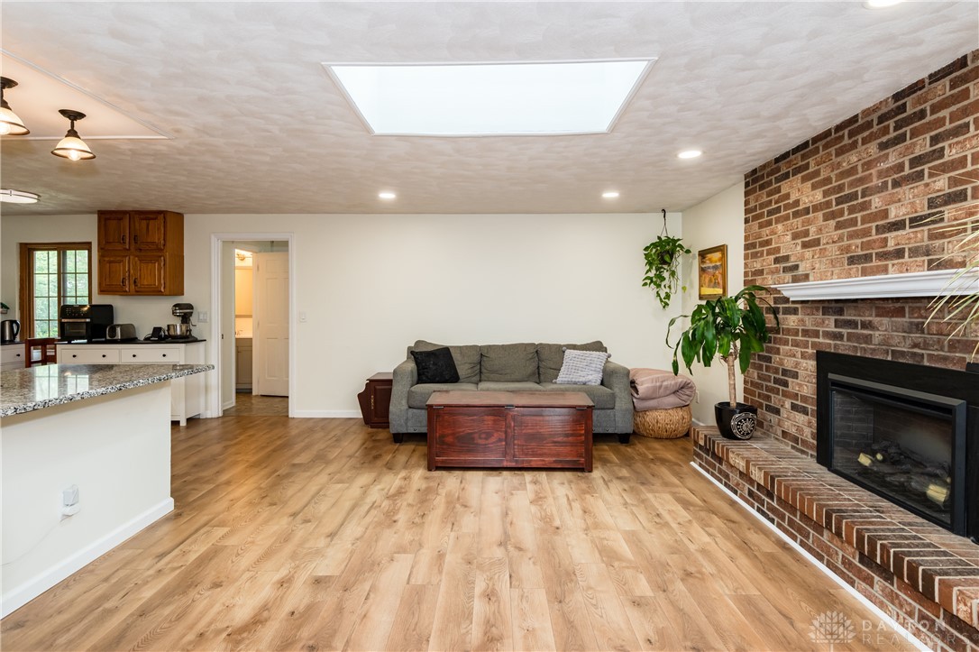 728 Chipplegate Drive Centerville, OH 45459 - Photo 11 of 30 This inviting space features an open layout, a brick fireplace, and durable flooring.