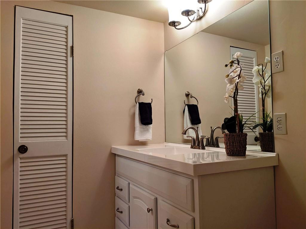 7650 West McNab Road, Unit 310 Tamarac, FL 33321 - Photo 11 of 30 a bathroom with a sink and a mirror