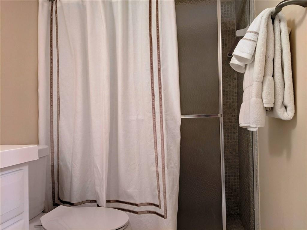 7650 West McNab Road, Unit 310 Tamarac, FL 33321 - Photo 12 of 30 a bathroom with a shower curtain and a sink