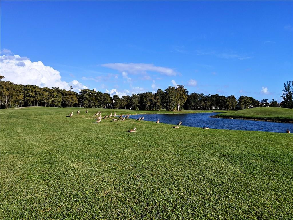 7650 West McNab Road, Unit 310 Tamarac, FL 33321 - Photo 28 of 30 a view of a golf course with a lake