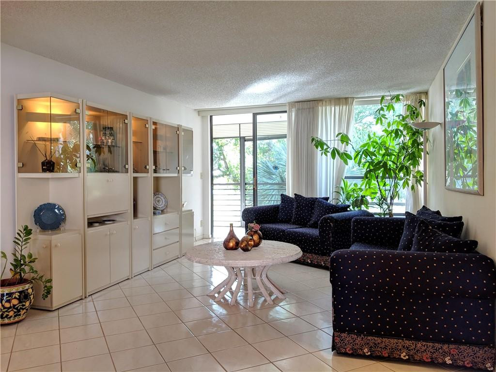 7650 West McNab Road, Unit 310 Tamarac, FL 33321 - Photo 3 of 30 a living room with furniture and a large window