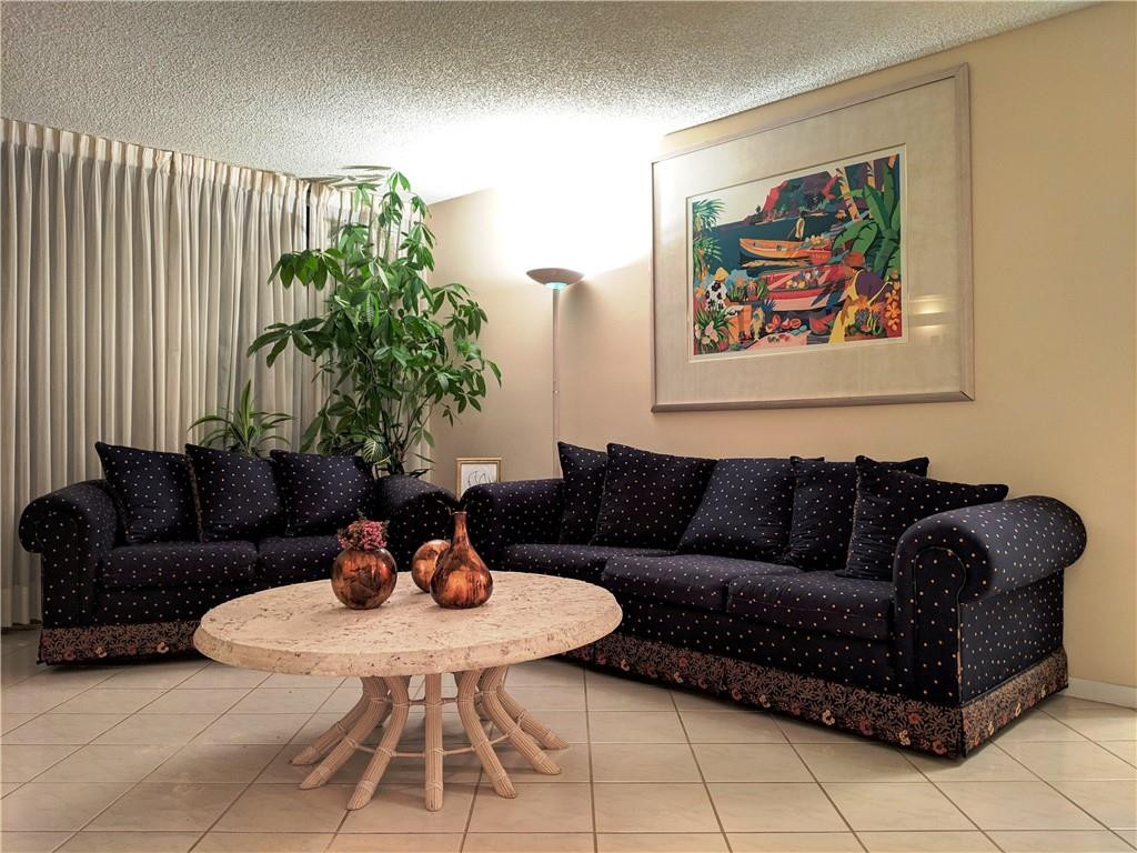 7650 West McNab Road, Unit 310 Tamarac, FL 33321 - Photo 6 of 30 a living room with furniture and a potted plant