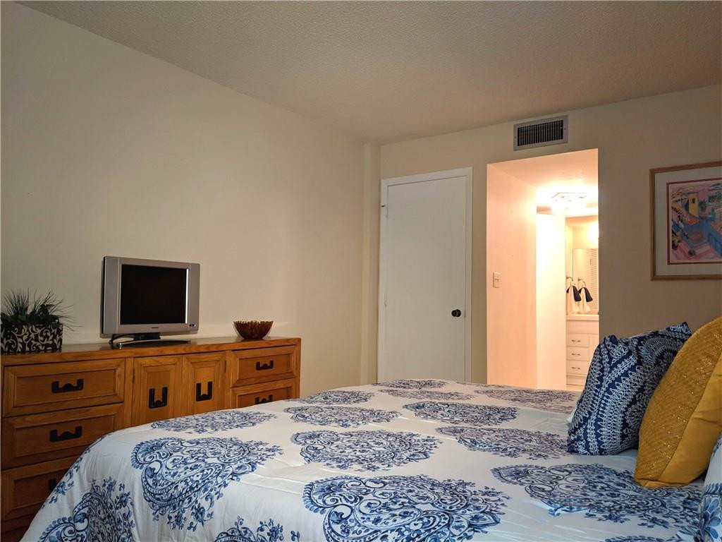 7650 West McNab Road, Unit 310 Tamarac, FL 33321 - Photo 8 of 30 a bedroom with a bed and a flat screen tv
