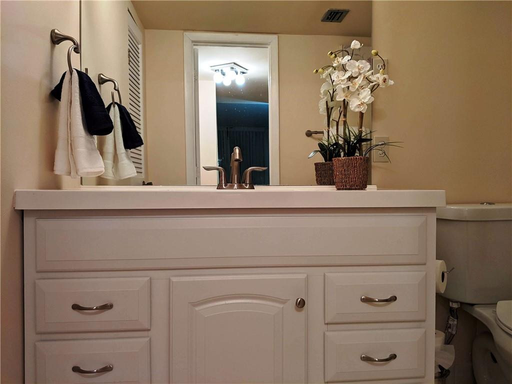 7650 West McNab Road, Unit 310 Tamarac, FL 33321 - Photo 10 of 30 a bathroom with a sink and a mirror