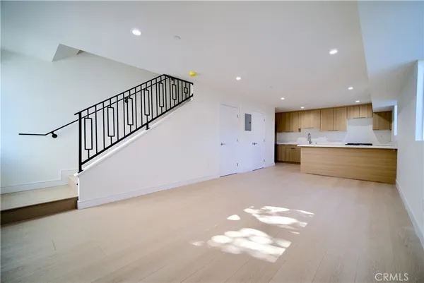 a kitchen with stainless steel appliances white cabinets and a sink
