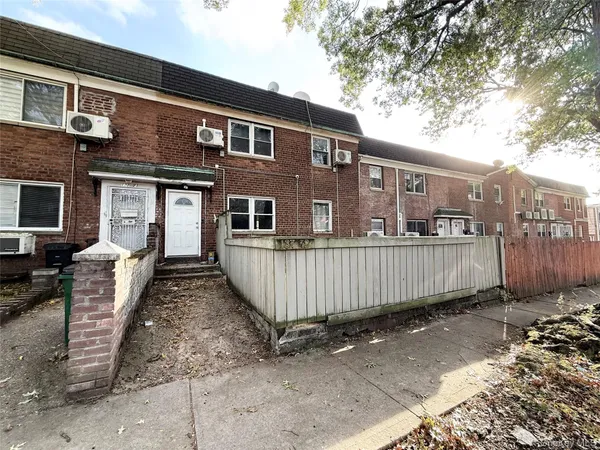 a front view of a house with a fence