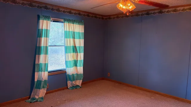 a view of an empty room and a window