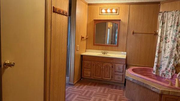 a bathroom with a sink a mirror and a shower