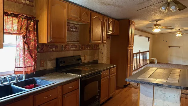 a kitchen that has a sink and a stove