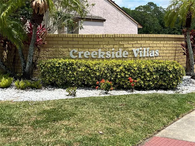 a view of a pathway with a garden