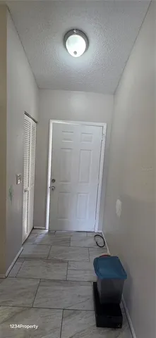 a view of an empty room and wooden floor