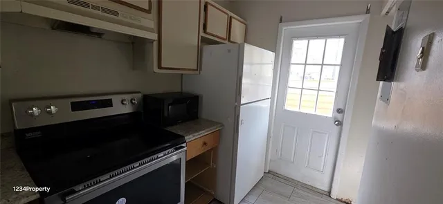 a view of a refrigerator in kitchen and wooden floor