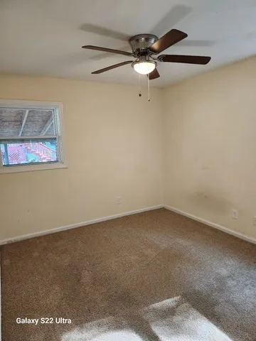 an empty room with a fan