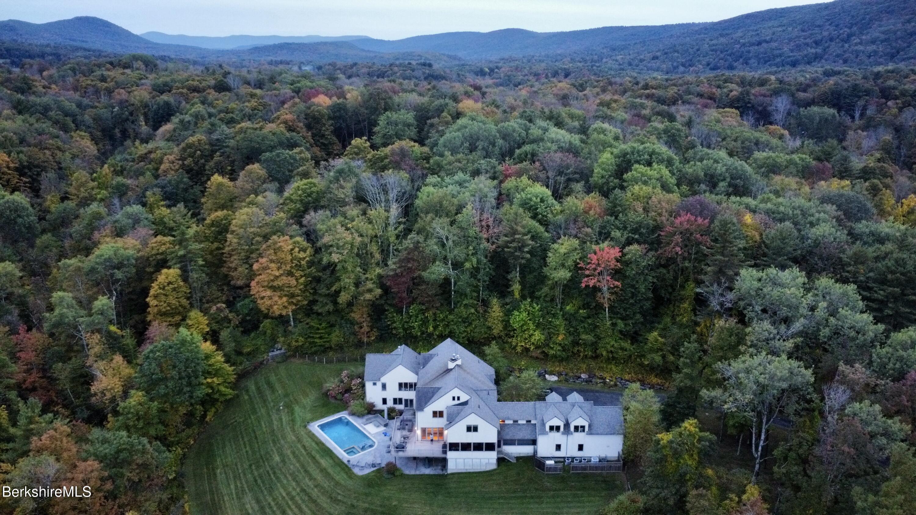 an aerial view of a house with a garden and trees