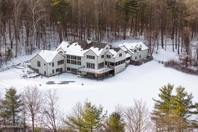 an aerial view of a house with a garden and trees