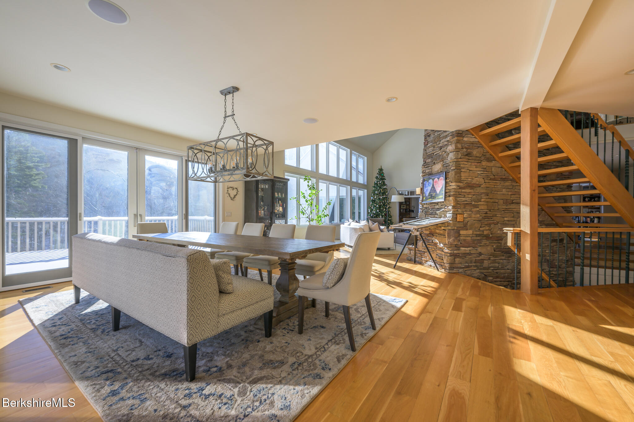83 Maple Hill Road West Stockbridge, MA 01266 - Photo 18 of 86 a living room with couches a dining table and chairs with wooden floor
