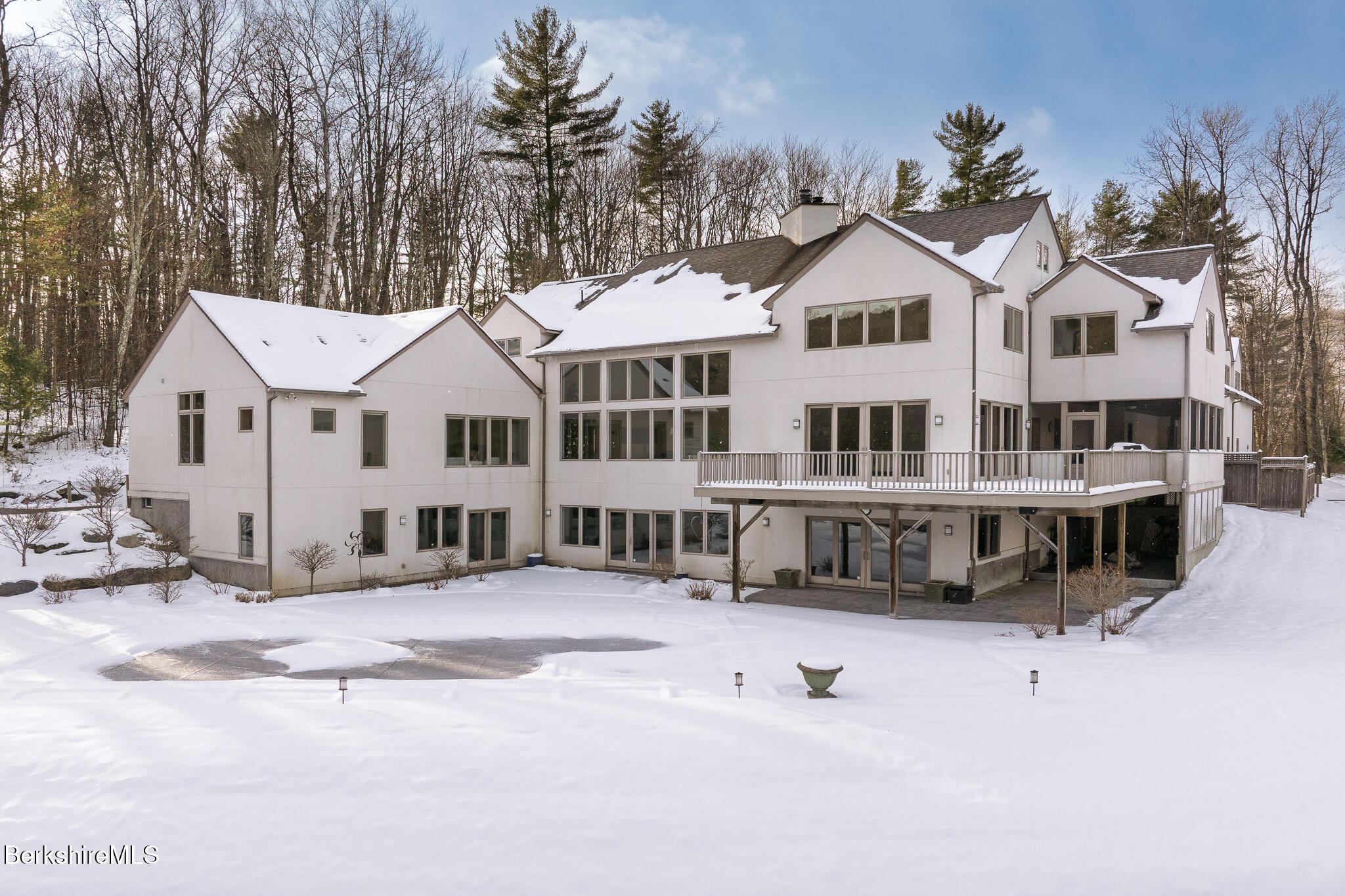 83 Maple Hill Road West Stockbridge, MA 01266 - Photo 78 of 86 a view of a white house with a large tree with wooden fence