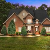a front view of a house with a yard table and chairs