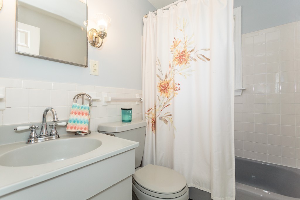 5 George Road, Unit 5 Winchester, MA 01890 - Photo 17 of 21 a bathroom with a sink a toilet and shower curtain