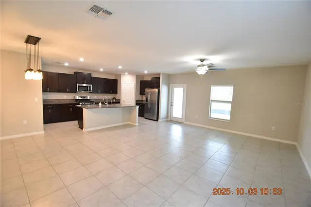 a view of a kitchen with microwave and cabinets