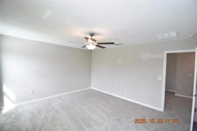 a view of walk in closet with white walls and shower