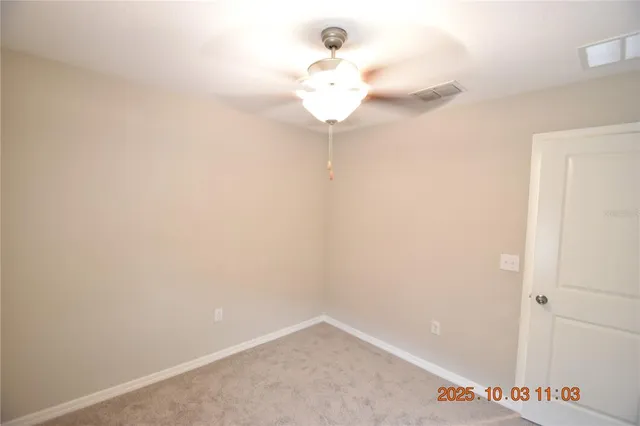 a view of a livingroom with a chandelier fan