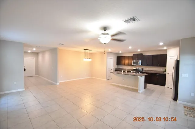 a view of kitchen with kitchen island microwave and stove
