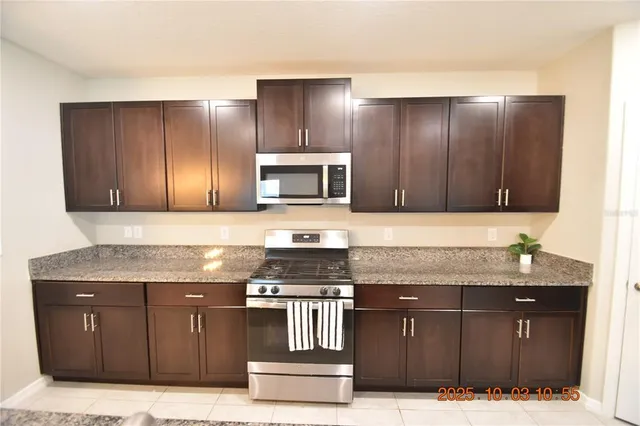a kitchen with granite countertop cabinets and black stainless steel appliances