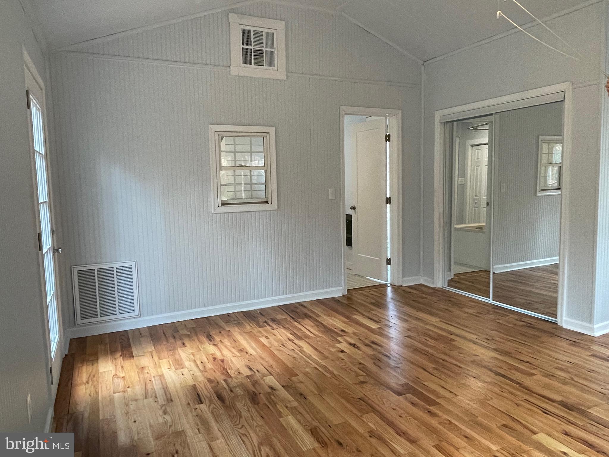 240 Whorton Hollow Road Castleton, VA 22716 - Photo 20 of 24 a view of an empty room with wooden floor and a window