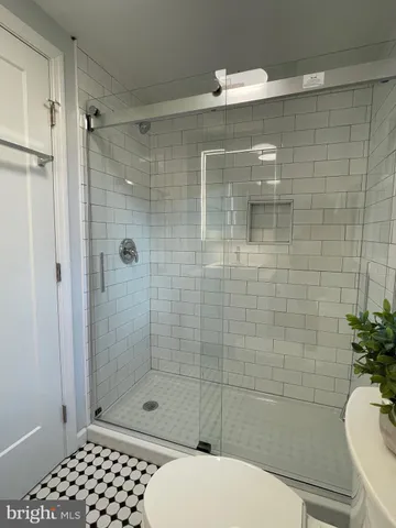 a bathroom with a shower a toilet and a sink