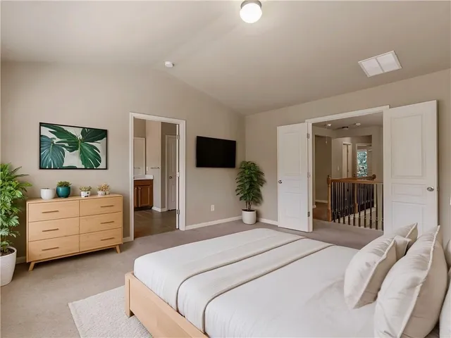 a bedroom with a bed and a large window