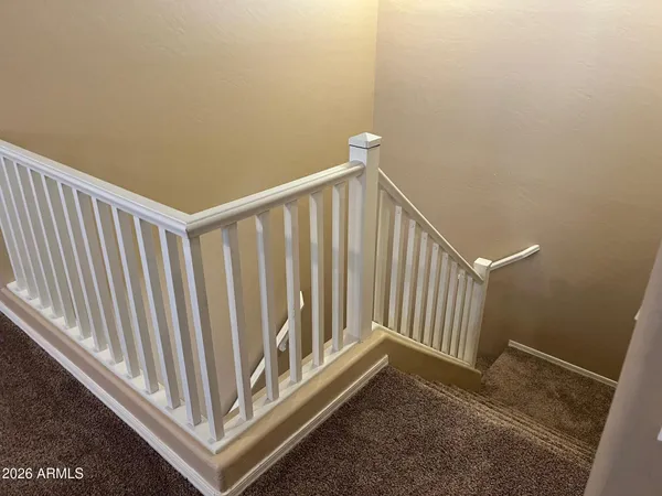 a view of a hallway with stairs