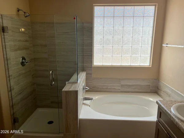 a bathroom with a bathtub and shower