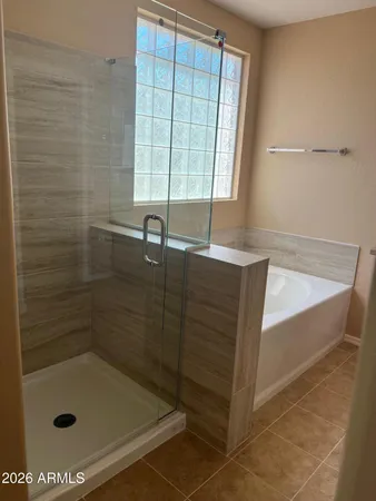 a bathroom with a shower and a sink
