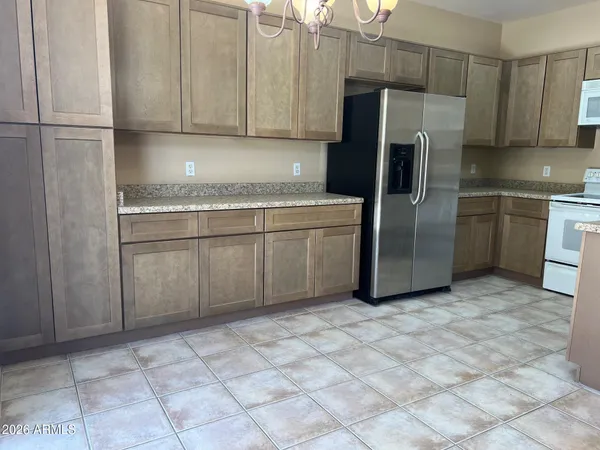 a kitchen with stainless steel appliances granite countertop a refrigerator sink and cabinets