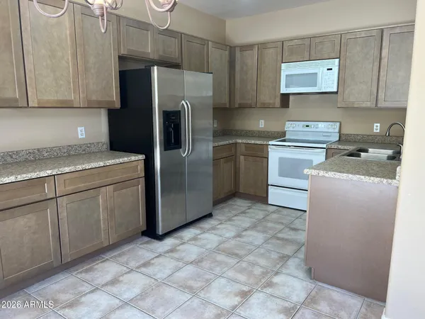 a kitchen with a stove sink and refrigerator