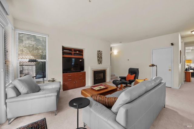 a living room with furniture fireplace and flat screen tv