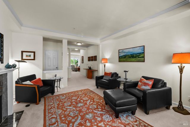 a living room with furniture a rug and wall painting