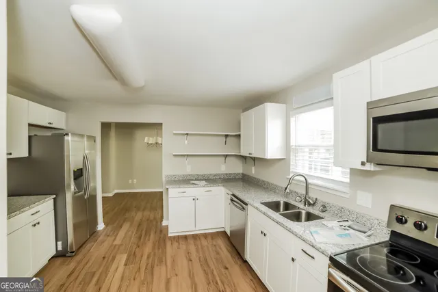 a kitchen with a sink stove and refrigerator