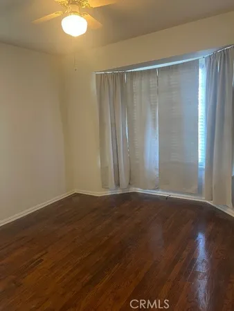 a view of wooden floor and brick walls