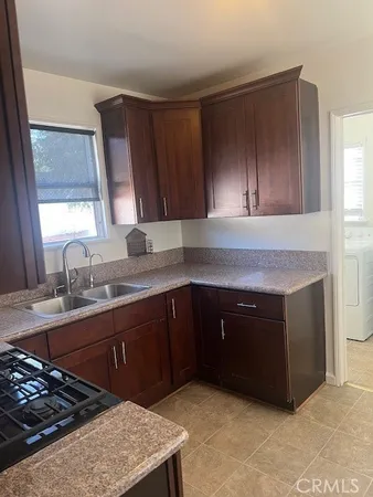 a kitchen with a sink stove and cabinets