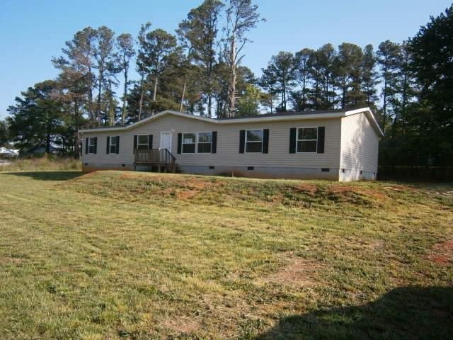 1257 Village Road Elberton, GA 30635 - Photo 1 of 1 a house that has a tree in front of it