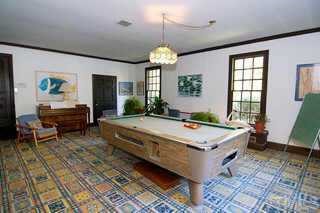 3224 Landor Road Raleigh, NC 27609 - Photo 8 of 10 a spacious bedroom with a large bed a chandelier and windows