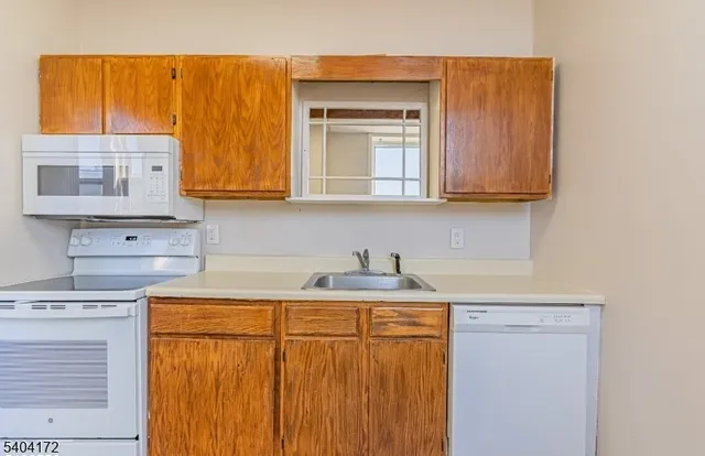 a kitchen with a sink a cabinets and window
