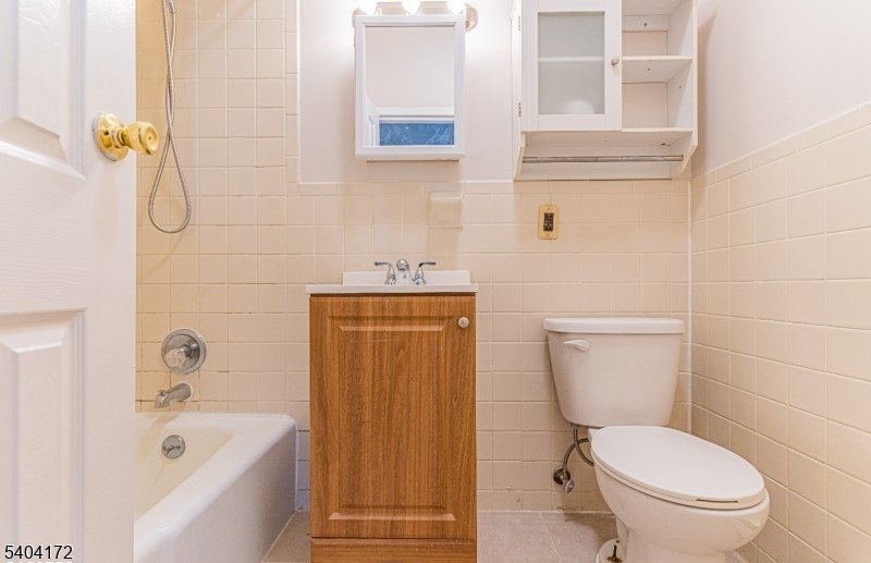 110 Cornelia Street, Unit 3 Boonton, NJ 07005 - Photo 9 of 15 a white toilet sitting next to a bath tub