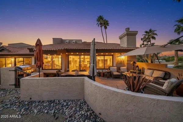 a living room with furniture and floor to ceiling window