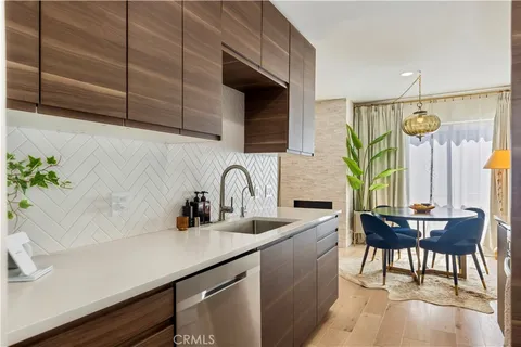 a kitchen with a sink cabinets and window